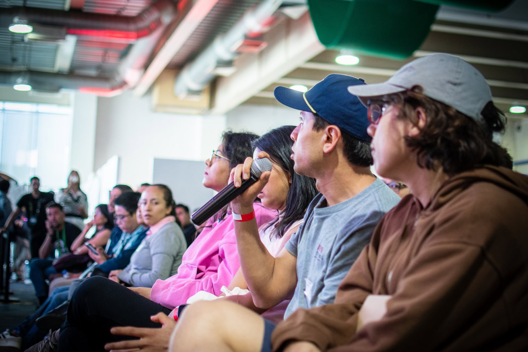 An attendee asks a question into the microphone from the audience