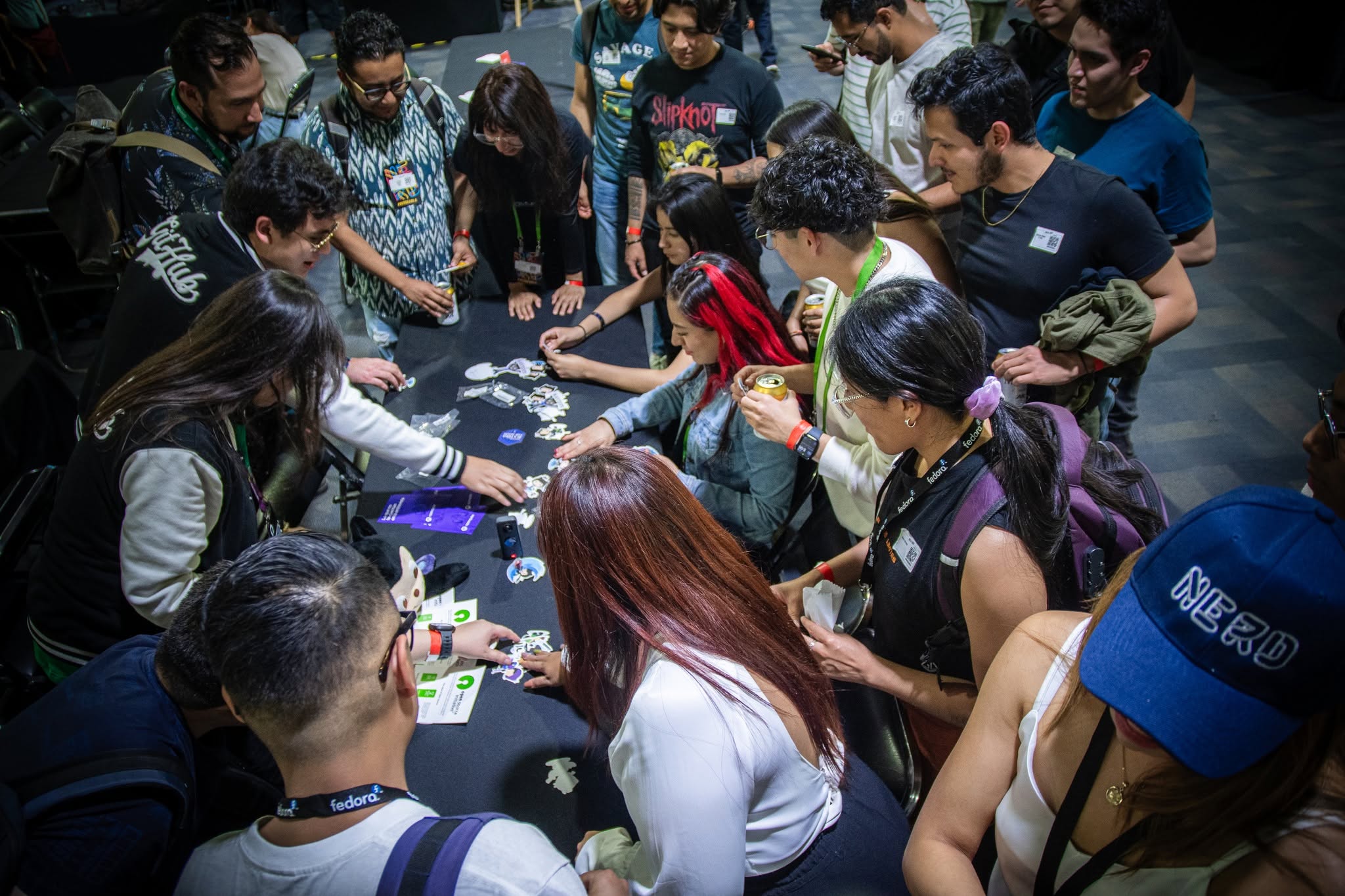 Attendees gathered around a table covered in stickers